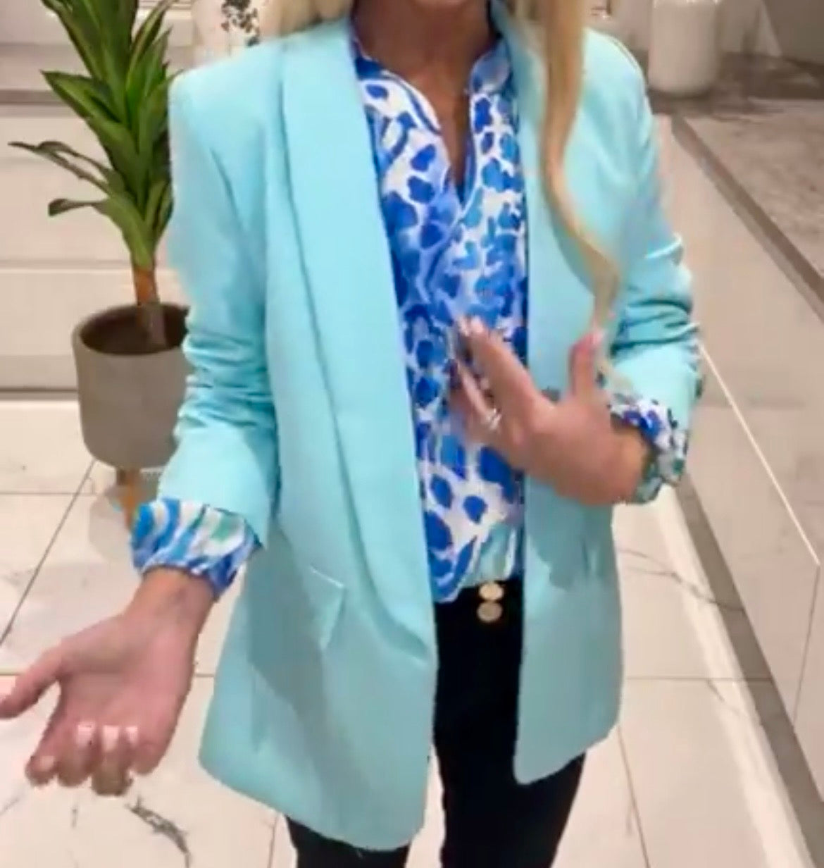 Person wearing a Belle Print Top in an indoor setting.