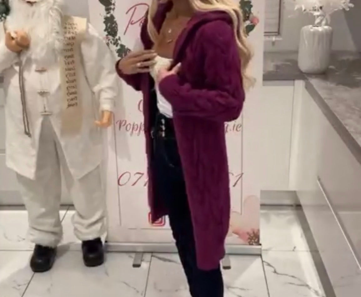 Person wearing a Gemma Hooded Cardigan coat in a store setting with a mannequin to the left.