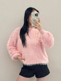 Person wearing a Chloe Fluffy Jumper sweater taking a mirror selfie.