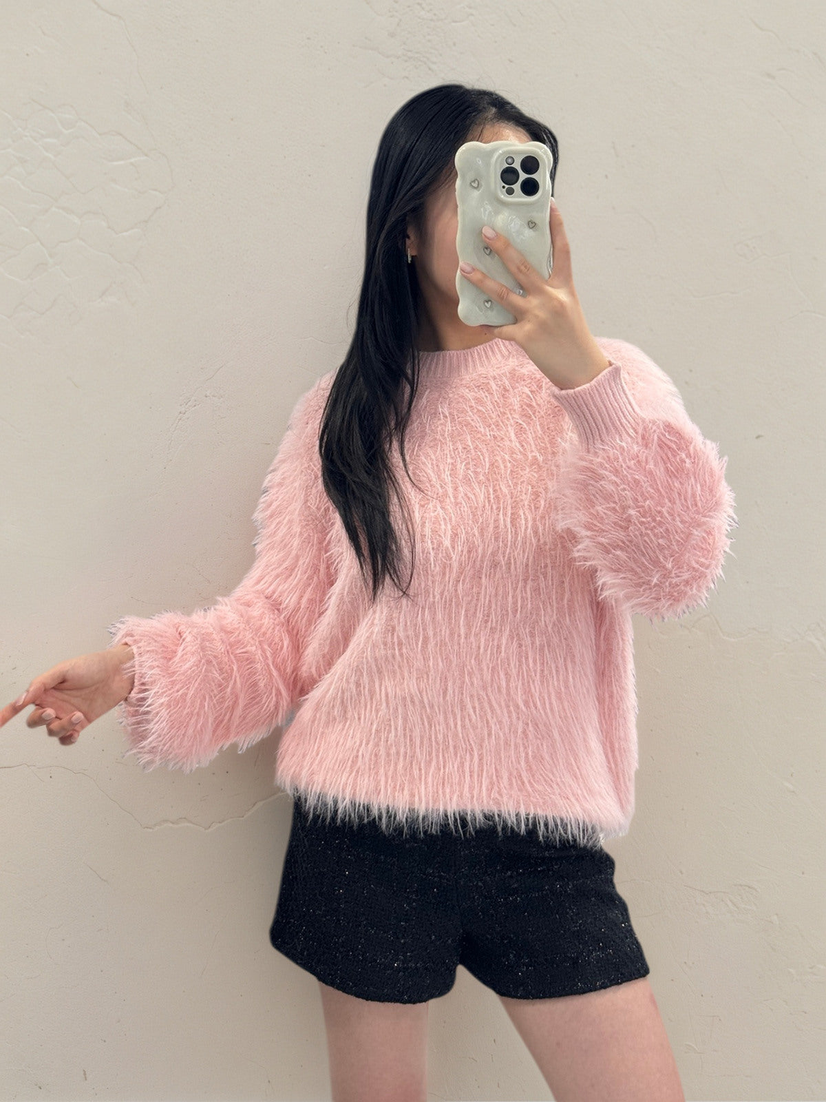 Person wearing a Chloe Fluffy Jumper and black shorts against a plain background