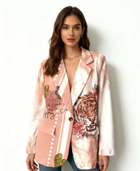 Woman wearing a pink satin jacket  name "Christina print blazer" with a tiger design and floral elements on a white background 