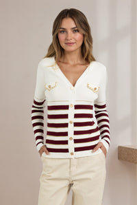 Woman wearing a white cardigan with red and brown striped sleeves against a neutral background "Cindy Stripe Knit"