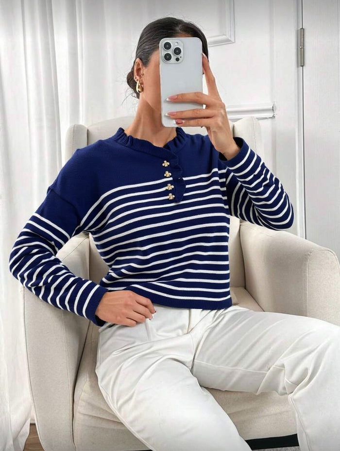 Person wearing a blue and white striped sweater sitting on a chair.  "Jimelle Stripe Knit "