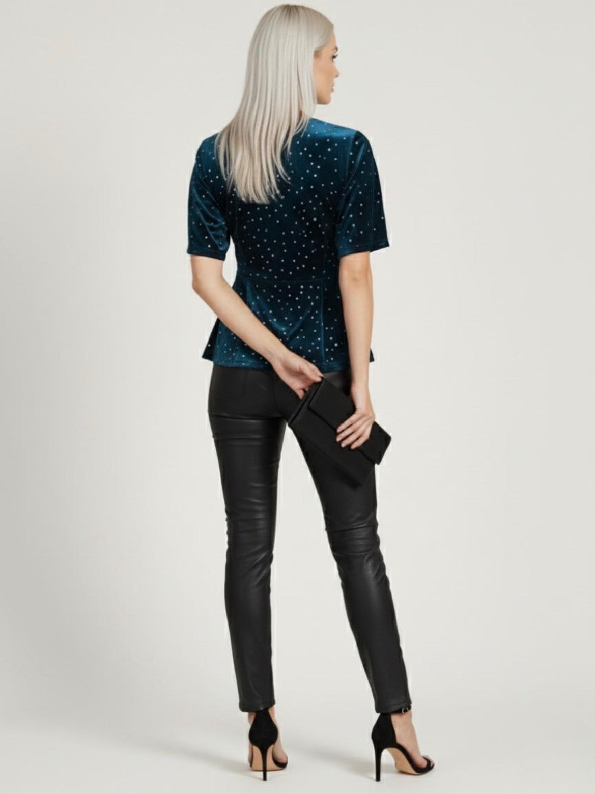 Woman wearing a dark blue sequin top and black leather pants on a white background. Joyce Sparkle Detail V-Neck Top – Elegant Party Blouse