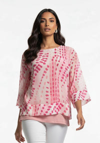 Woman wearing a pink patterned blouse with white pants on a light gray background Kayla Print Top