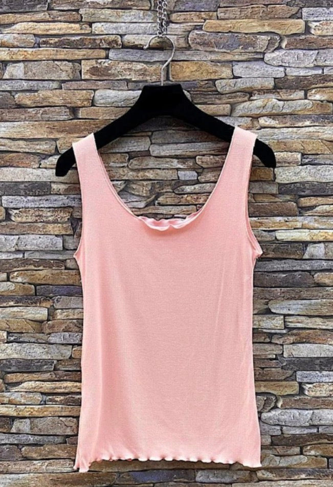 Pink tank top Lettuce Ribbed Cami on a hanger against a stone wall background