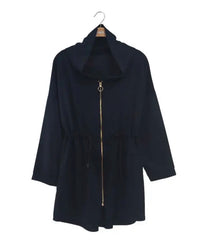 Navy blue coat on a hanger against a white background