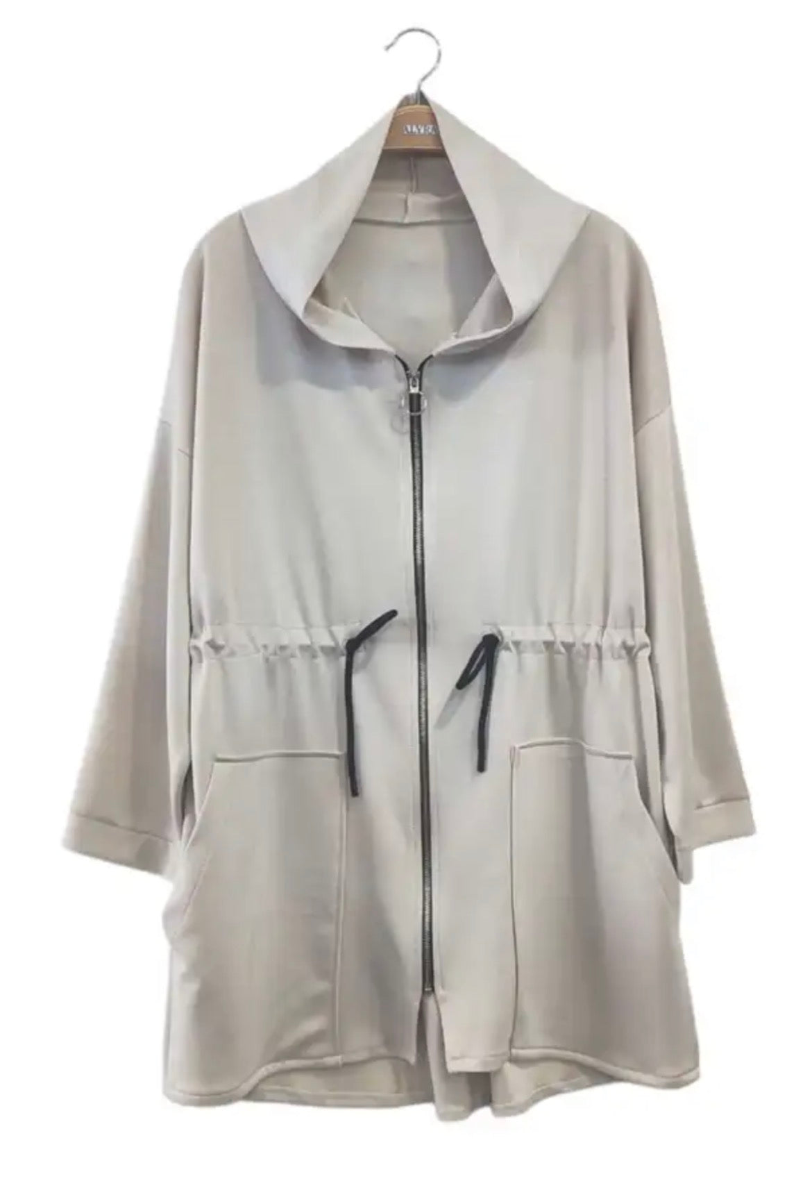 Beige jacket with a hood on a hanger against a white background