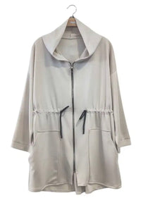 Beige jacket with a hood on a hanger against a white background