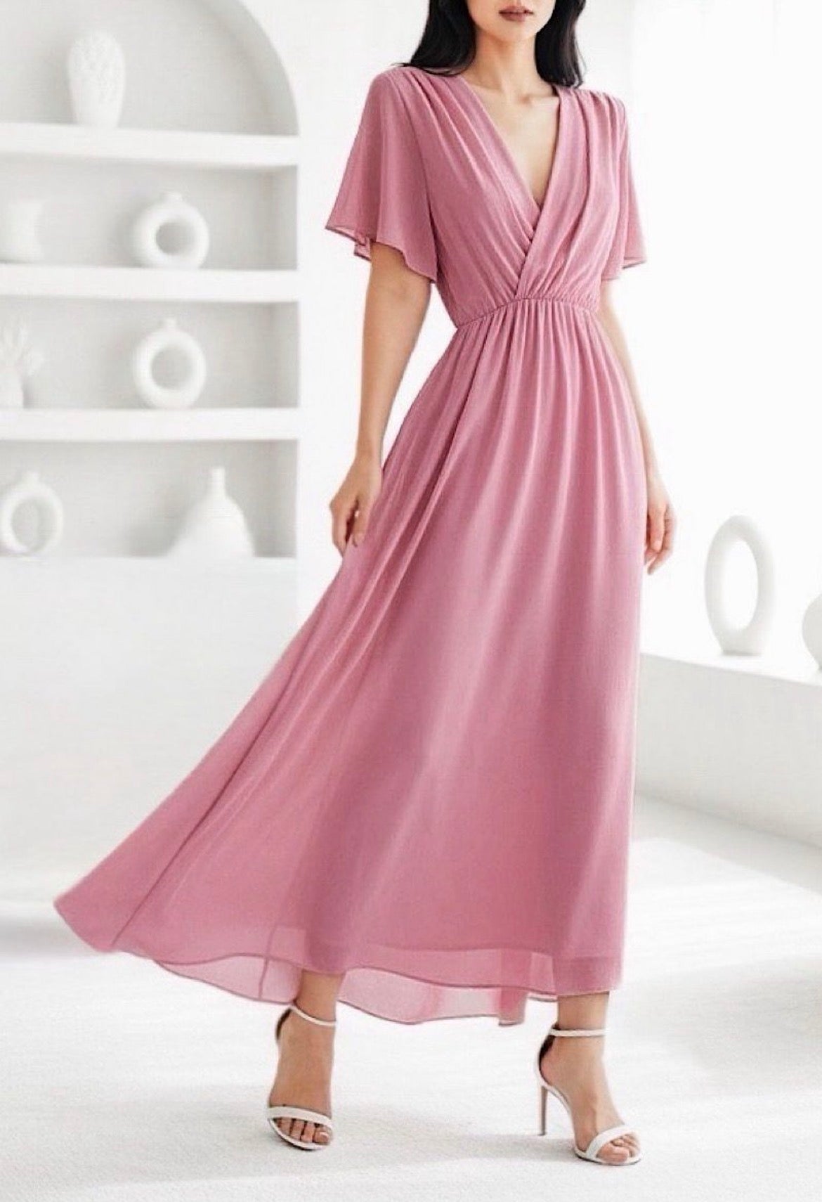 Pink dress worn by a model against a white background
