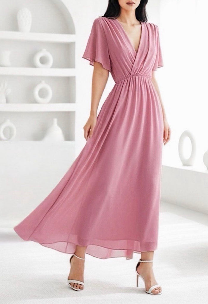 Pink dress worn by a model against a white background
