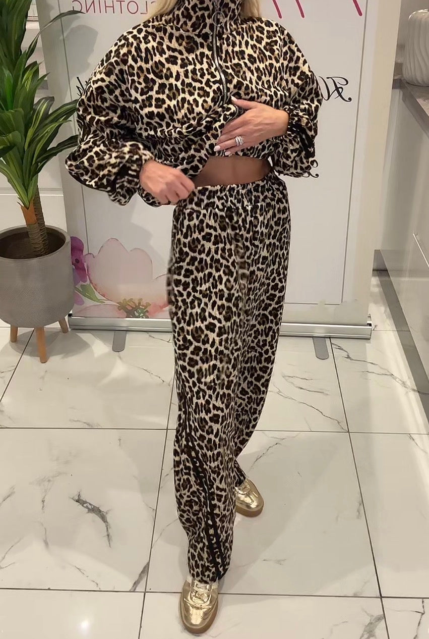 Person wearing a leopard print outfit in an indoor setting