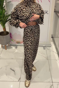 Person wearing a leopard print outfit in an indoor setting
