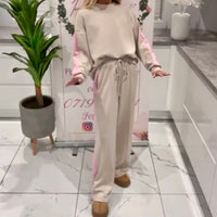 Person wearing a Melissa_Lounge_Set with pink accents in a modern interior setting.