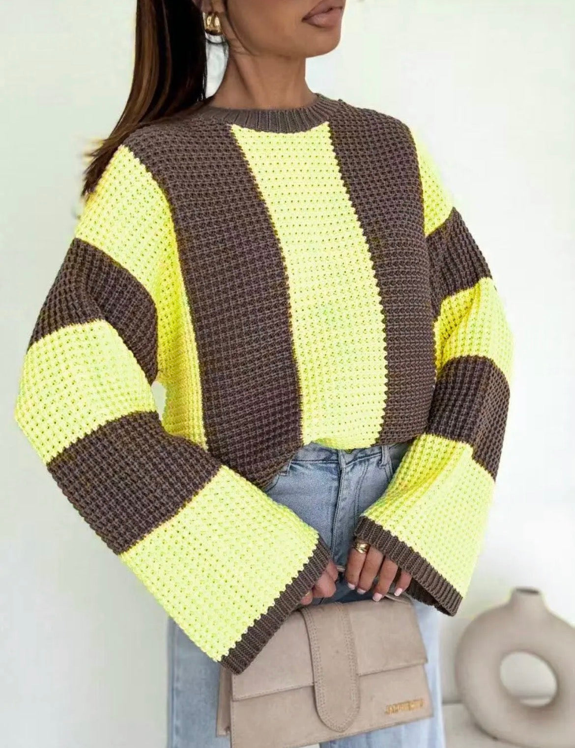 Person wearing a yellow and brown Noeleen Stripe Knit with a neutral background