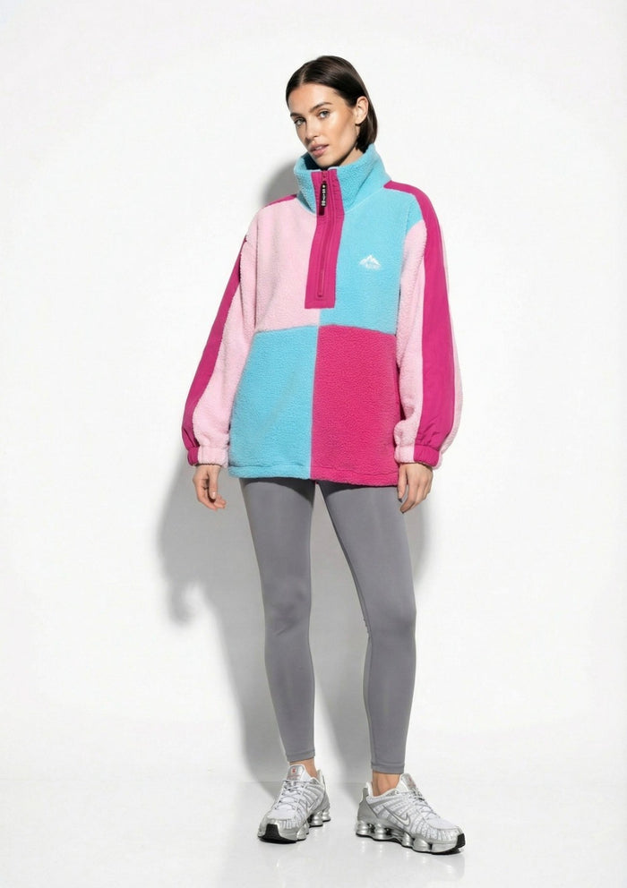 Person wearing a Poppy Half Zip Fleece with a brand logo on a white background