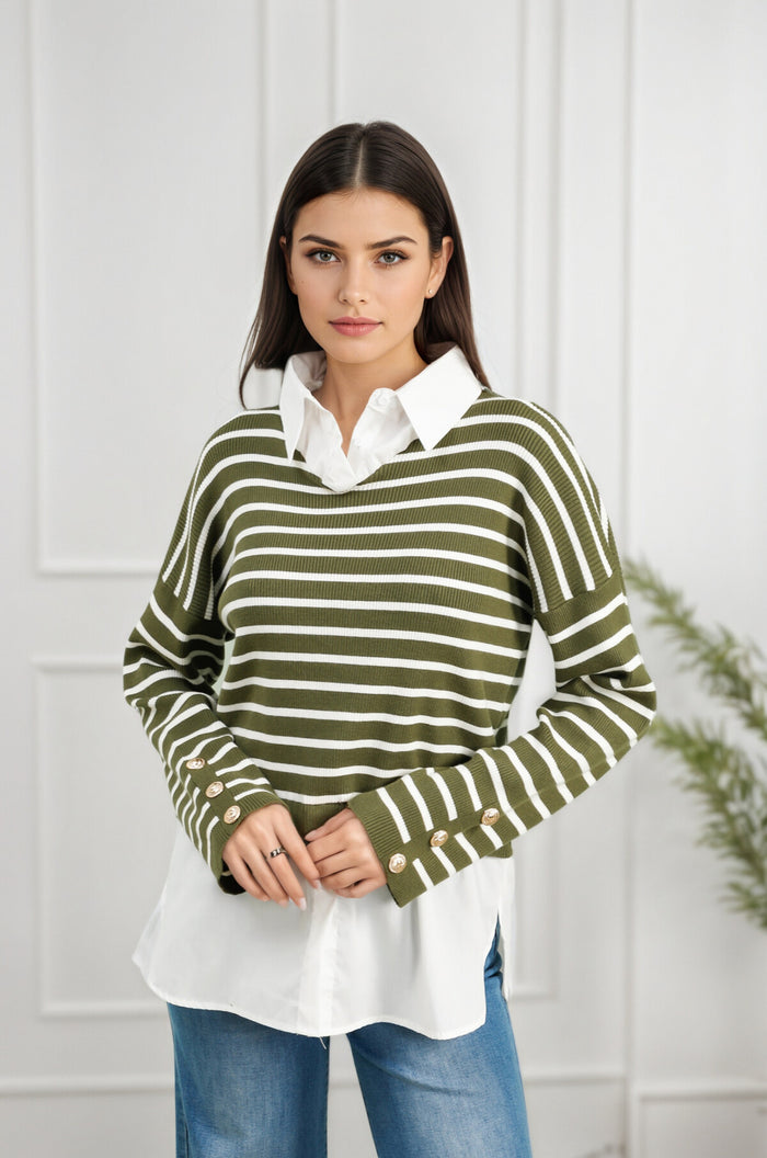 Woman wearing a green and white striped sweater over a white shirt with blue jeans against a white wall. "Sami Stripe Shirt Detail Jumper"