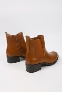 Pair of brown leather boots on a white background