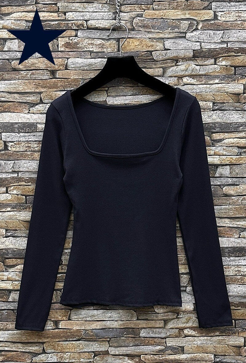 Susie Square Neck Basic Top Black long-sleeve top on a hanger against a stone wall background