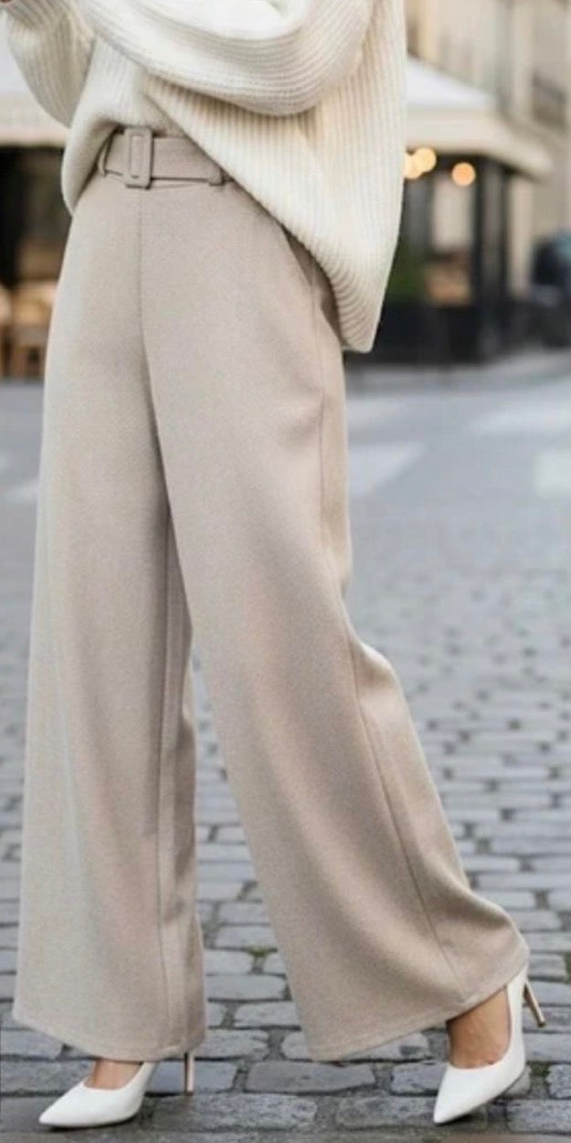 Beige Wide Leg Pants ireland worn with a white sweater and white shoes on a blurred street background.