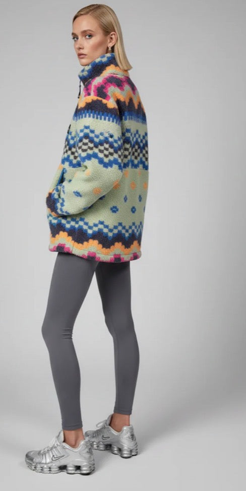 Person wearing a trek fleece mint & blue sweater and gray leggings on a plain background