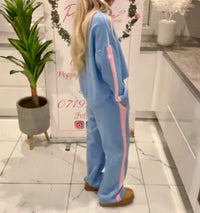 Person wearing a melissa-lounge-set with pink stripes in an indoor setting.